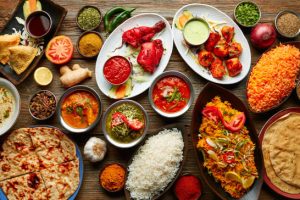 Assorted Indian recipes food various with spices and rice on wooden table